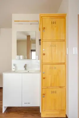 a bathroom with a sink and a wooden cabinet at \u6771\u6d45\u83492\u4e01\u76eeb201 in Tokyo