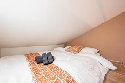 a bedroom with a bed with a robe on it at Plaza de La Brea in Tokyo