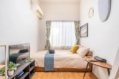 a small bedroom with a bed and a window at Plaza de La Brea in Tokyo