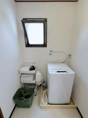 a bathroom with a toilet and a sink and a window at W-inns okazaki in Tokyo