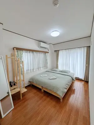 a bedroom with a bed and a wooden floor at W-inns okazaki in Tokyo