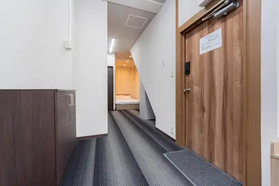 a hallway with a wooden door in a hospital at \u6d45\u8349\u30a2\u30d1\u30fc\u30c8\u30e1\u30f3\u30c8 in Tokyo