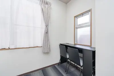 a dining room with a table and chairs and a window at \u6d45\u8349\u30a2\u30d1\u30fc\u30c8\u30e1\u30f3\u30c8 in Tokyo