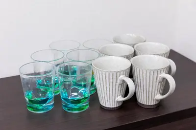 a group of cups and glasses on a table at \u6d45\u8349\u30a2\u30d1\u30fc\u30c8\u30e1\u30f3\u30c8 in Tokyo