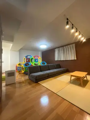 a living room with a couch and a table at Bliss KAMEARI in Tokyo