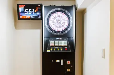 a game machine with a dart board in a room at Bliss KAMEARI in Tokyo