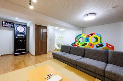 a living room with a couch and a video game at Bliss KAMEARI in Tokyo