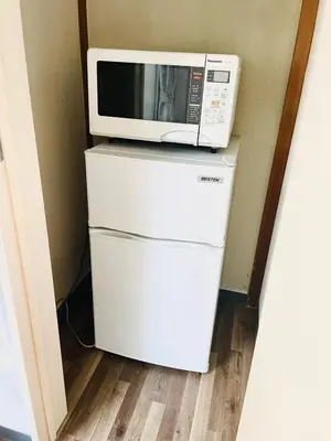 a microwave sitting on top of a refrigerator at RED House｜12 minutes from the station｜Quiet area｜Direct access to Shinjuku & Akihabara in Tokyo