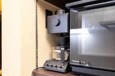 a kitchen with a coffee maker and a microwave at Asakura Ninja House Tokyostoryhotel, Tokyo Skytree in Tokyo