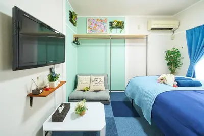 a bedroom with a bed and a flat screen tv at Belmont 202 3min to Station Easy Access Ueno Asakusa Skytree Sleeps 5 in Tokyo