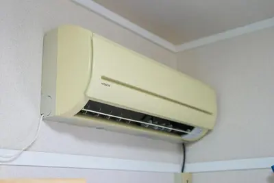a microwave oven hanging on a wall in a room at Belmont 202 3min to Station Easy Access Ueno Asakusa Skytree Sleeps 5 in Tokyo
