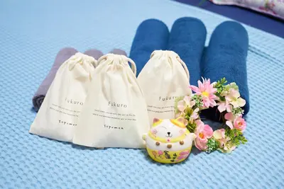 a table with two bags and a small bouquet of flowers at Belmont 202 3min to Station Easy Access Ueno Asakusa Skytree Sleeps 5 in Tokyo