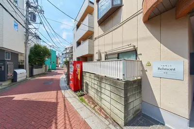 a building with a sign on the side of a street at Belmont 203 3min to Station Easy Access Ueno Asakusa Skytree Sleeps 4 in Tokyo