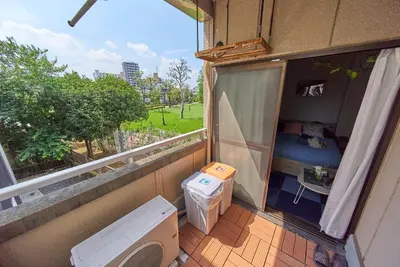 a balcony with a room with a bed and a window at Belmont 203 3min to Station Easy Access Ueno Asakusa Skytree Sleeps 4 in Tokyo