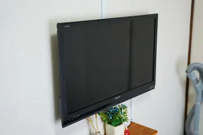 a flat screen tv hanging on a wall at Belmont 301 3min to Station Easy Access Ueno Asakusa Skytree Sleeps 5 in Tokyo