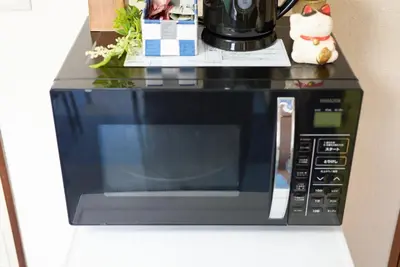 a microwave oven sitting on top of a counter at Belmont 301 3min to Station Easy Access Ueno Asakusa Skytree Sleeps 5 in Tokyo