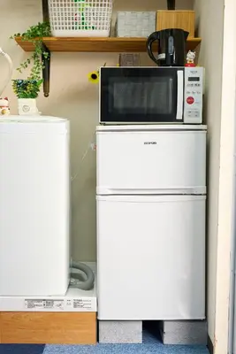a microwave sitting on top of a refrigerator at Belmont 302 3min to Station Easy Access Ueno Asakusa Skytree Sleeps 5 in Tokyo