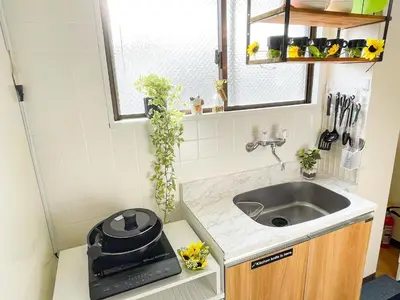 a small kitchen with a sink and a mirror at Belmont 302 3min to Station Easy Access Ueno Asakusa Skytree Sleeps 5 in Tokyo