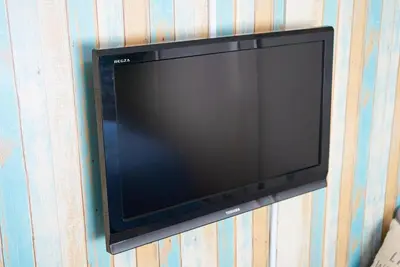 a flat screen tv hanging on a wall at Belmont 302 3min to Station Easy Access Ueno Asakusa Skytree Sleeps 5 in Tokyo