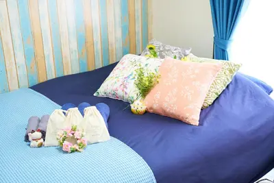 a blue bed with stuffed animals and pillows on it at Belmont 302 3min to Station Easy Access Ueno Asakusa Skytree Sleeps 5 in Tokyo