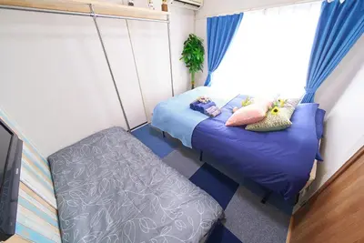 a bedroom with two beds and a window at Belmont 302 3min to Station Easy Access Ueno Asakusa Skytree Sleeps 5 in Tokyo