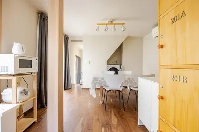 a kitchen and dining room with a table and chairs at \u6771\u6d45\u83492\u4e01\u76eeb202 in Tokyo