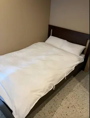 a bed with white sheets and pillows in a room at \u6771\u6d45\u83492\u4e01\u76ee\u6238\u5efa in Tokyo