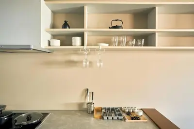 a kitchen with white shelves and a counter top at \u6771\u6d45\u83492\u4e01\u76ee\u6238\u5efa in Tokyo
