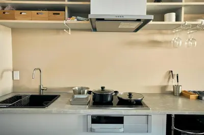 a kitchen with two pots sitting on a stove at \u6771\u6d45\u83492\u4e01\u76ee\u6238\u5efa in Tokyo