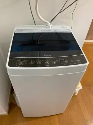 a microwave oven sitting on top of a floor at Maison Shin Nakano 203 MS23 in Tokyo