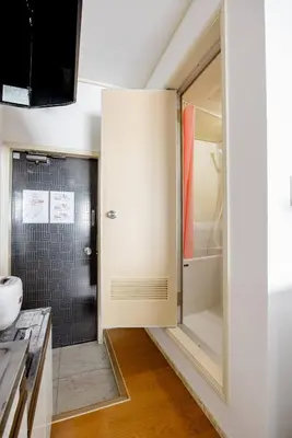 a bathroom with a shower and a glass door at Maison Shin Nakano 203 MS23 in Tokyo