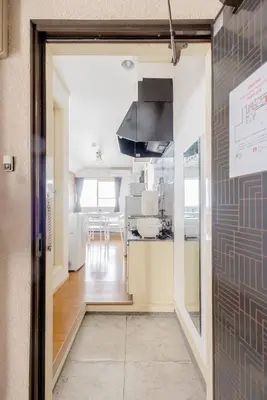 a view of a kitchen from the hallway of a building at Maison Shin Nakano 203 MS23 in Tokyo