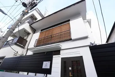 a white building with a balcony on it at Asakusa 5 Chome KazeNoItsu Home in Tokyo