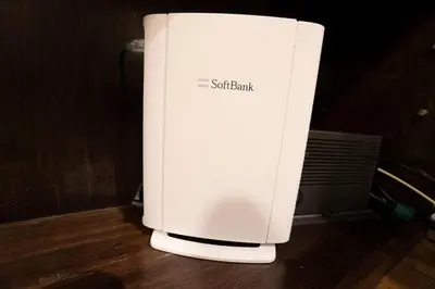 a white computer monitor sitting on a wooden floor at Jarudan Building 2F - Vacation STAY 17316 in Tokyo