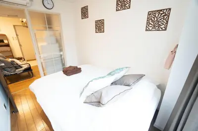 a bedroom with a white bed with pillows on it at Jarudan Building 2F - Vacation STAY 17316 in Tokyo