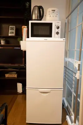 a white refrigerator with a microwave on top of it at Jarudan Building 2F - Vacation STAY 17316 in Tokyo