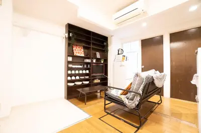 a living room with a chair and a wine cellar at Jarudan Building 2F - Vacation STAY 17316 in Tokyo