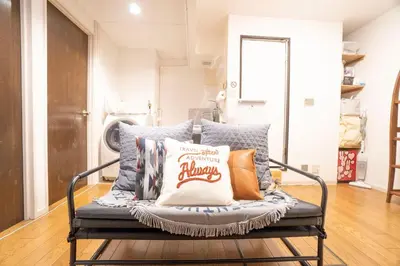 a bench with pillows on it in a living room at Jarudan Building 2F - Vacation STAY 17316 in Tokyo