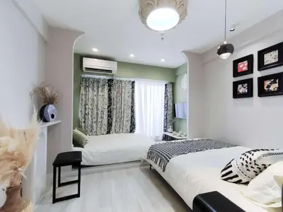 a bedroom with two beds and a window at Shibuya Center-\u6e0b\u8c37\u7ad9\u5f92\u6b654min-\u65b0\u5bbf\u516d\u672c\u6728\u4e0a\u91ce\u76f4\u8fbe-New Open Max4P in Tokyo