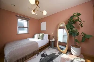 a bedroom with a bed and a mirror at NEW! Pufuka Oshiage \u3077\u3075\u304b\u62bc\u4e0a in Tokyo