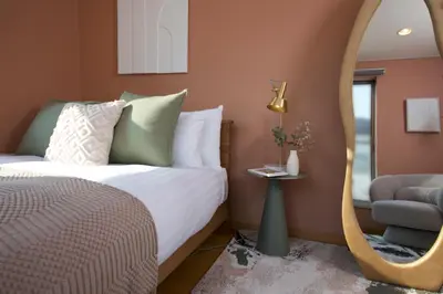 a bedroom with a bed and a mirror and a chair at NEW! Pufuka Oshiage \u3077\u3075\u304b\u62bc\u4e0a in Tokyo