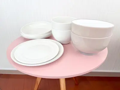 a pink table with three bowls and plates on it at Ikebukuro-Kanamecho Studio - 2 Seconds from Kanamecho Station - Comfortable & Central 3F in Tokyo
