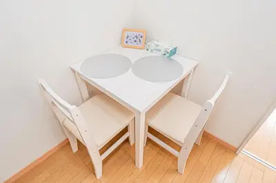 a white table with two chairs and a box of gift at mori house\u897f\u304c\u4e18 in Tokyo