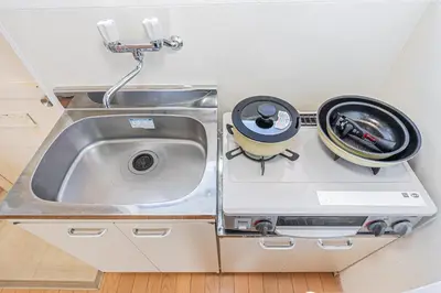 a kitchen counter with a sink and a frying at mori house\u897f\u304c\u4e18 in Tokyo