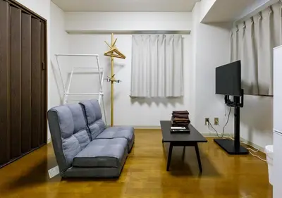 a living room with a couch and a table at Benir Maison Izumi in Tokyo