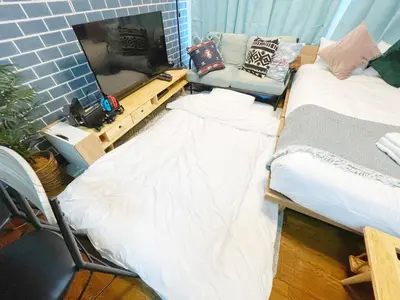 a living room with two beds and a couch at LVB Shibuyadogenzaka in Tokyo