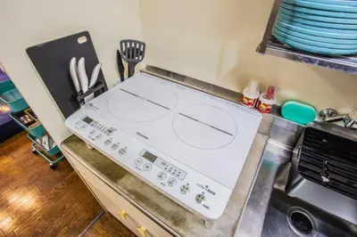 a stove top oven in a kitchen with some dishes at LVB Shibuyadogenzaka in Tokyo