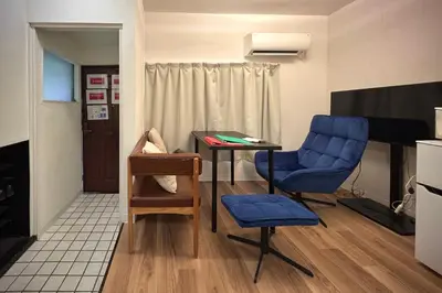 a small room with a table and a blue chair at Green & Orange House - Economic APT in Tokyo Tranquil Block, with Direct Access to Ginza & Akihabara in Tokyo