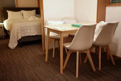 a room with a table and chairs and a bed at Green & Orange House - Economic APT in Tokyo Tranquil Block, with Direct Access to Ginza & Akihabara in Tokyo