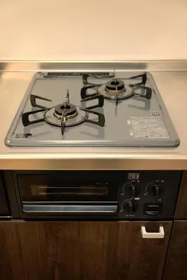 a stove top oven sitting on top of a counter at Green & Orange House - Economic APT in Tokyo Tranquil Block, with Direct Access to Ginza & Akihabara in Tokyo
